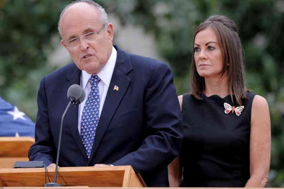 Former New York City Mayor Rudolph W. Giuliani (left) speaks with his wife, Judith Nathan, at his side in New York City. 