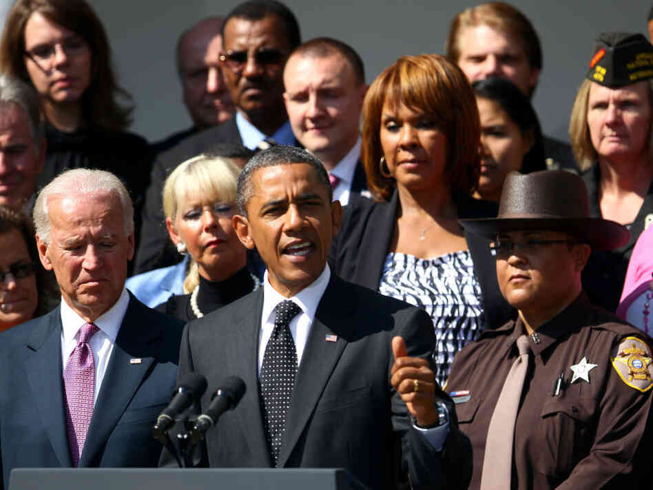 President Obama, flanked by Vice President Joe Biden and teachers, veterans, construction workers, police officers and firefighters, introduces the American Jobs Act in the Rose Garden of the White House on Monday.