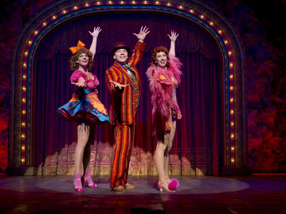 Blue Man, Grouped: Buddy Plummer (Danny Burstein, with Jenifer Foote and Kiira Schmidt) gets to bust loose at last with "Buddy's Blues" in the show's final sequence, known as Loveland.