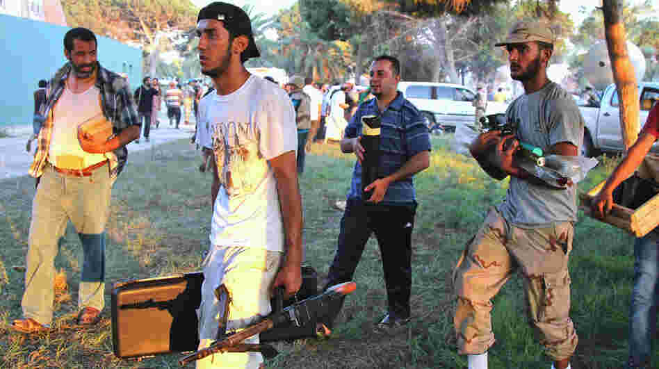 Libyans take weapons from Moammar Gadhafi's compound in Tripoli last month. There are concerns that looted weapons could contribute to instability in Libya as the country tries to establish a new government.