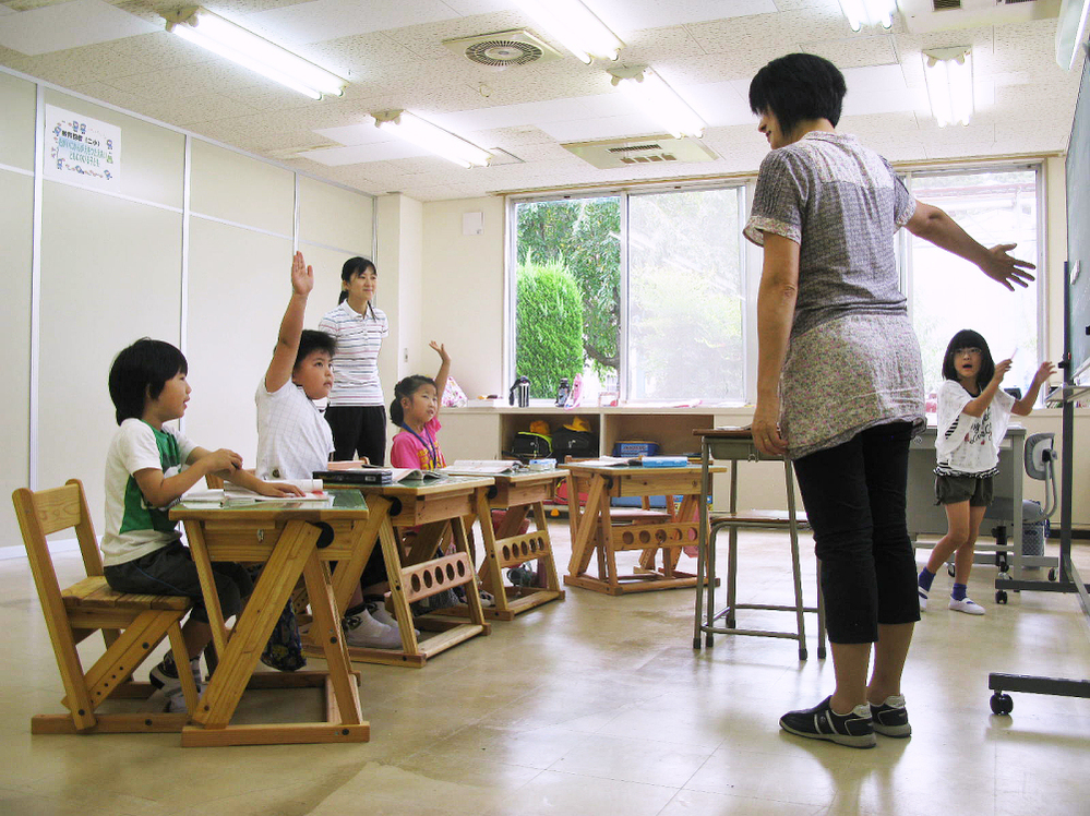 Four first-grade students study at the Tomioka Town Joint  Temporary School. The school, housed into a  soon-to-be-abandoned auto parts factory, is home to refugee pupils from  Fukushima  prefecture's radiation zone.