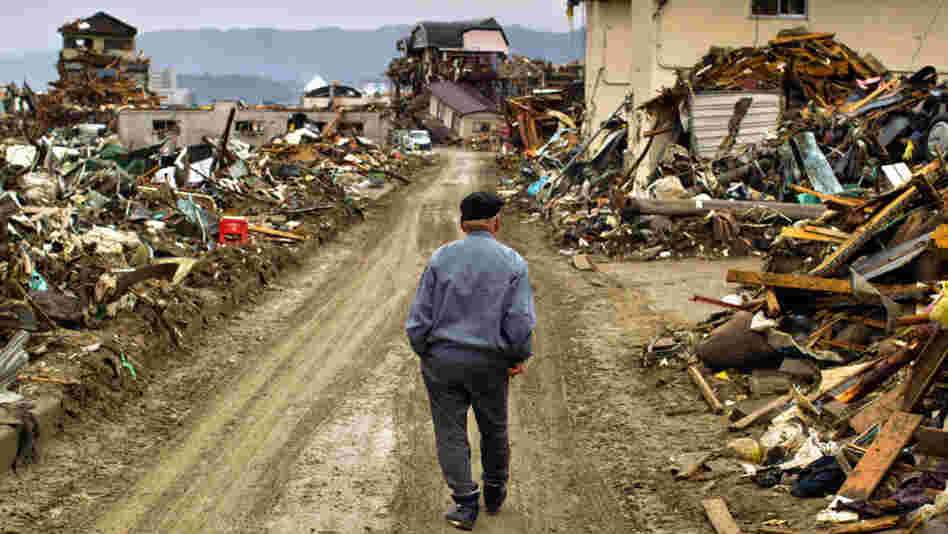 A 9.0-magnitude earthquake struck Japan offshore on March 11, setting into motion a tsunami that engulfed large parts of northeastern Japan and triggered a nuclear meltdown at a power plant in Fukushima. On March 26, a man walks among debris in Rikuzentakata, Iwate Prefecture, Japan. A 9.0-magnitude earthquake struck Japan offshore on March 11, setting into motion a tsunami that engulfed large parts of northeastern Japan and triggered a nuclear meltdown at a power plant in Fukushima. On March 26, a man walks among debris in Rikuzentakata, Iwate Prefecture, Japan.