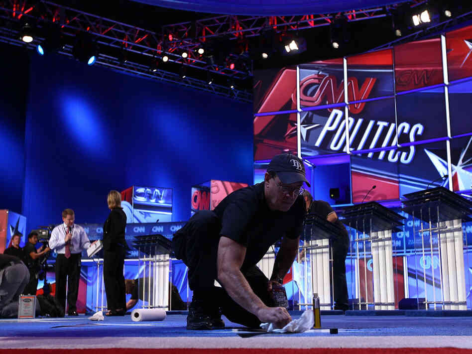 A worker cleans the stage for Monday evening's Republican presidential debate sponsored by CNN and the Tea Party Express, Sept. 12, 2011.