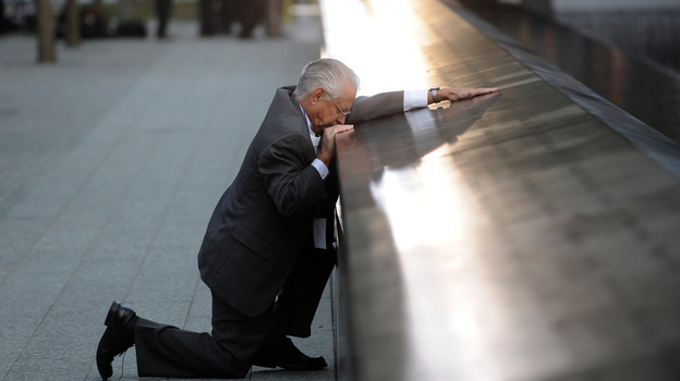 Robert Peraza, who lost his son Robert David Peraza, pauses at his son's name at the North Pool of the 9/11 Memorial at the site of the World Trade Center.