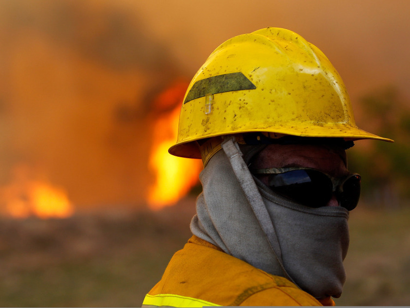 Volunteer firefighter Jason Collard at a wildfire in Strawn, Texas, in April.