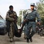 Afghan security officials carry the body of a fallen comrade after several armed Taliban militants launched attacks in Kabul, Afghanistan, on Tuesday.