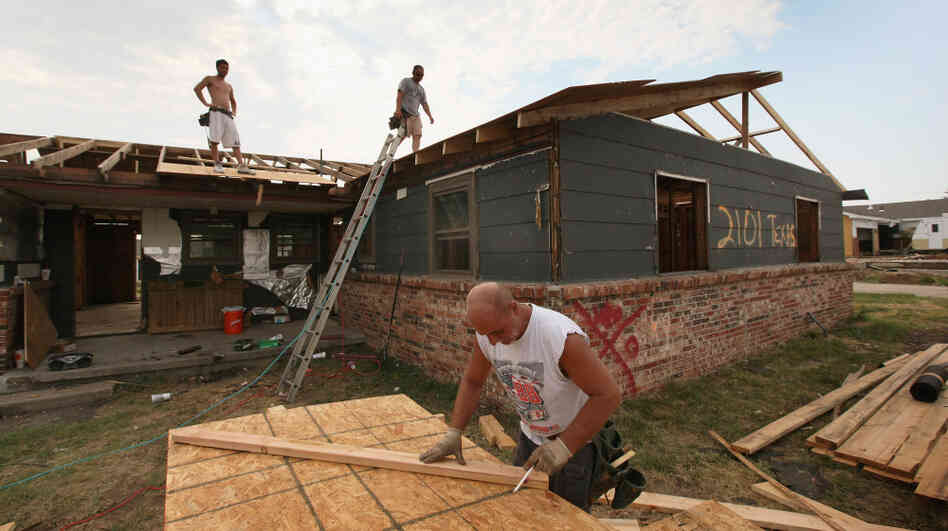 Anthony Owens (right) repairs the roof of a tornado-damaged home with James Davis (left) and Dwain Payne on July 30 in Joplin, Mo. All three men came up from Mobile, Ala., looking for work after the May 22 tornado that devastated Joplin, killing 160 people and destroying 7,500 homes and as many as 500 businesses. Anthony Owens (right) repairs the roof of a tornado-damaged home with James Davis (left) and Dwain Payne on July 30 in Joplin, Mo. All three men came up from Mobile, Ala., looking for work after the May 22 tornado that devastated Joplin, killing 160 people and destroying 7,500 homes and as many as 500 businesses.