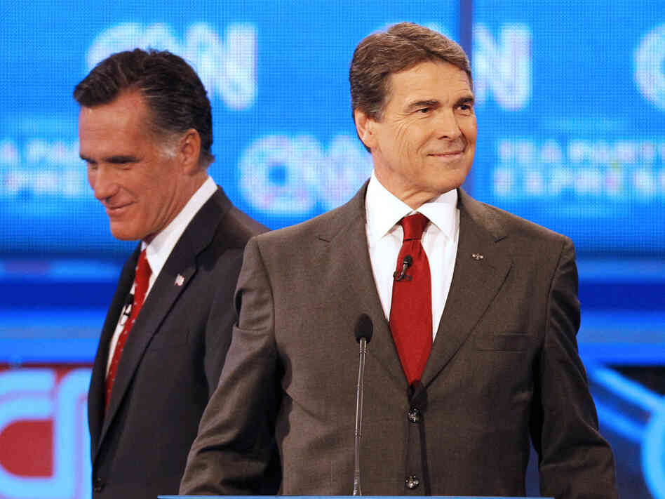 Republican presidential candidate former Massachusetts Gov. Mitt Romney (left) passes behind Texas Gov. Rick Perry during a break in a Republican debate Monday in Tampa, Fla. Republican presidential candidate former Massachusetts Gov. Mitt Romney (left) passes behind Texas Gov. Rick Perry during a break in a Republican debate Monday in Tampa, Fla.