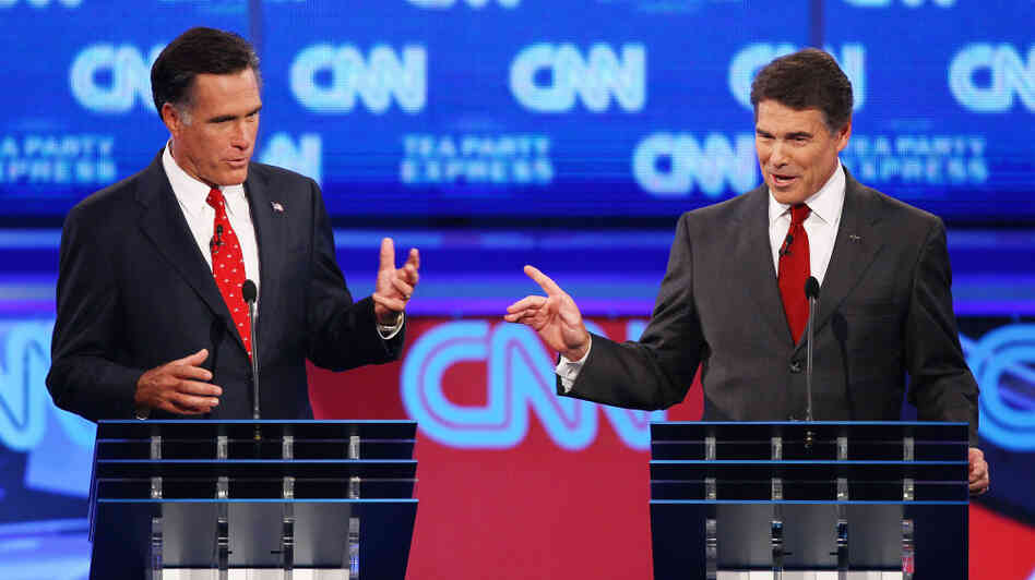 Former Massachusetts Gov Mitt Romney (left) and Texas Gov. Rick Perry during Monday's debate in Tampa.