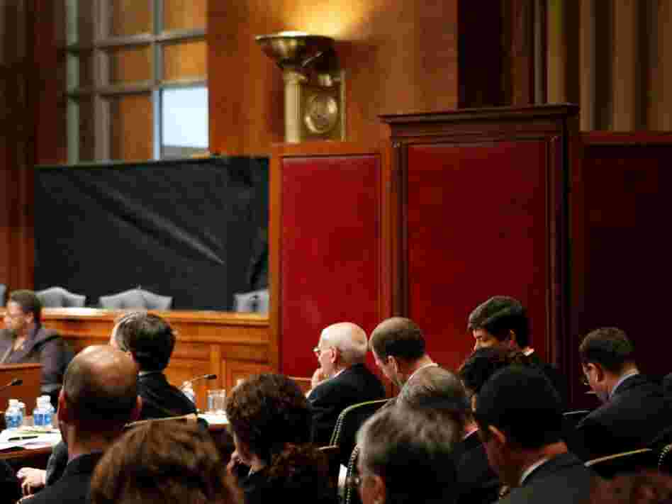 Ali Soufan testifies from behind a black curtain and a room divider to protect his identity in 2009, during a Senate hearing to examine the Bush administration's detention and interrogation program.