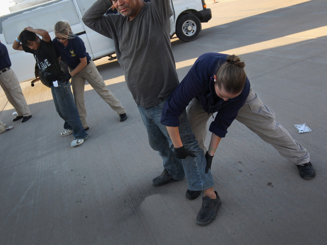 Undocumented Guatemalan immigrants in Arizona are body-searched before boarding a deportation flight to Guatemala in June.