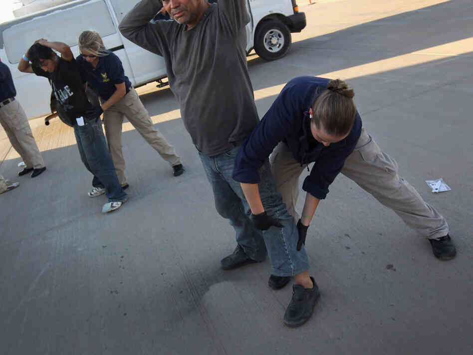 Undocumented Guatemalan immigrants in Arizona are body-searched before boarding a deportation flight to Guatemala in June.