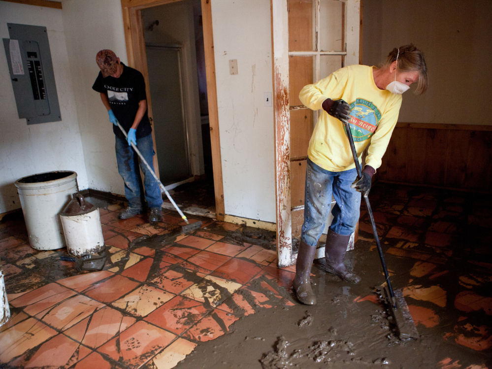 Joyce Roy (right) and Oscar Smith clean up mud from flooding caused by Tropical Storm Irene, in an apartment on West Main Street last month in Wilmington, Vt. The nearby Deerfield River overflowed its banks a few days earlier, inundating homes and businesses in the downtown area. Joyce Roy (right) and Oscar Smith clean up mud from flooding caused by Tropical Storm Irene, in an apartment on West Main Street last month in Wilmington, Vt. The nearby Deerfield River overflowed its banks a few days earlier, inundating homes and businesses in the downtown area.