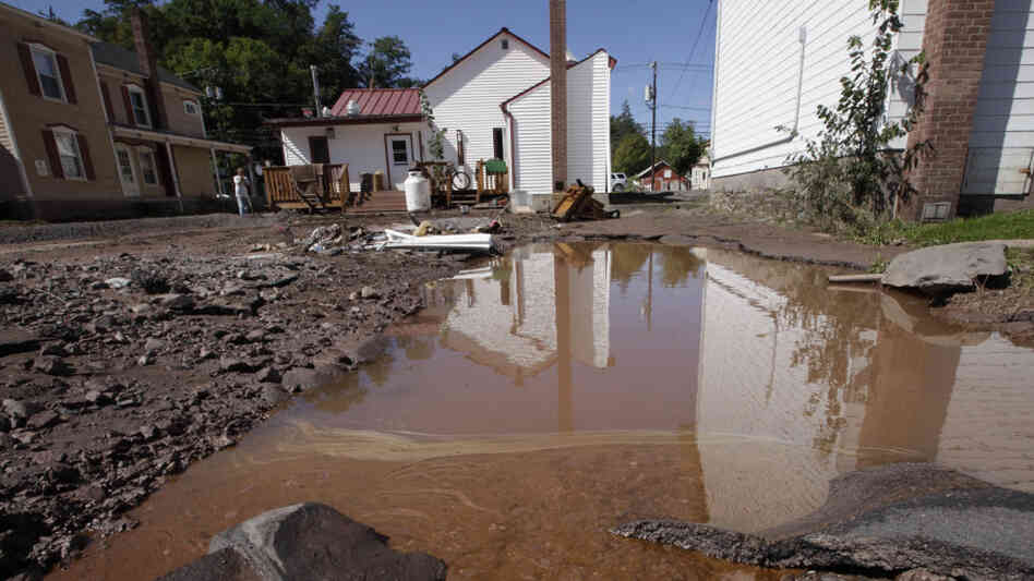 Water mixed with gasoline accumulated in the Zerega's pizzeria parking lot last month in Windham, N.Y. More than a dozen towns in Vermont and at least three in New York were cut off, with roads and bridges washed out by flooding caused by Tropical Storm Irene. Water mixed with gasoline accumulated in the Zerega's pizzeria parking lot last month in Windham, N.Y. More than a dozen towns in Vermont and at least three in New York were cut off, with roads and bridges washed out by flooding caused by Tropical Storm Irene.
