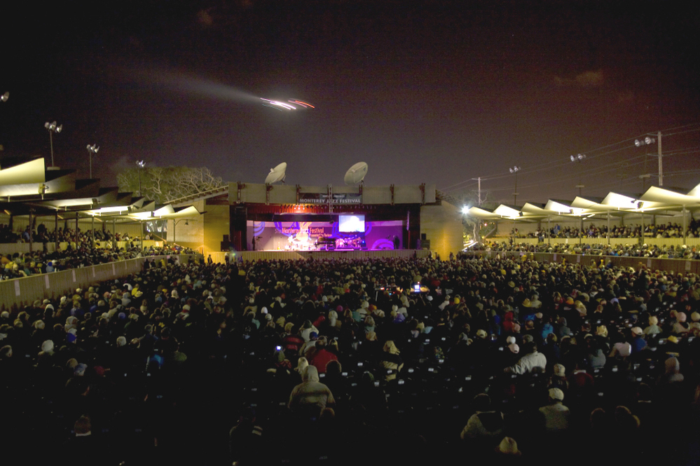 An airplane flies over the Arena Stage of the Monterey Jazz Festival.