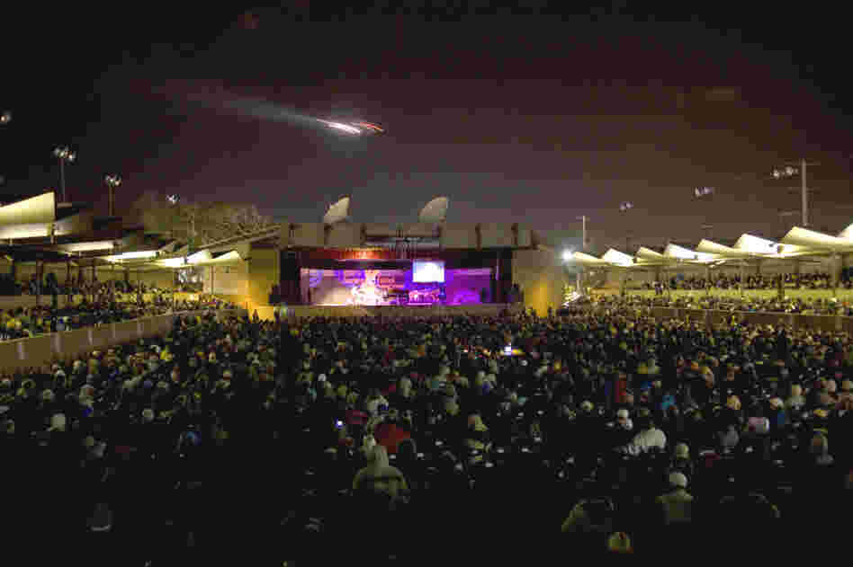 An airplane flies over the Arena Stage of the Monterey Jazz Festival.