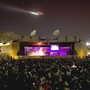An airplane flies over the Arena Stage of the Monterey Jazz Festival.