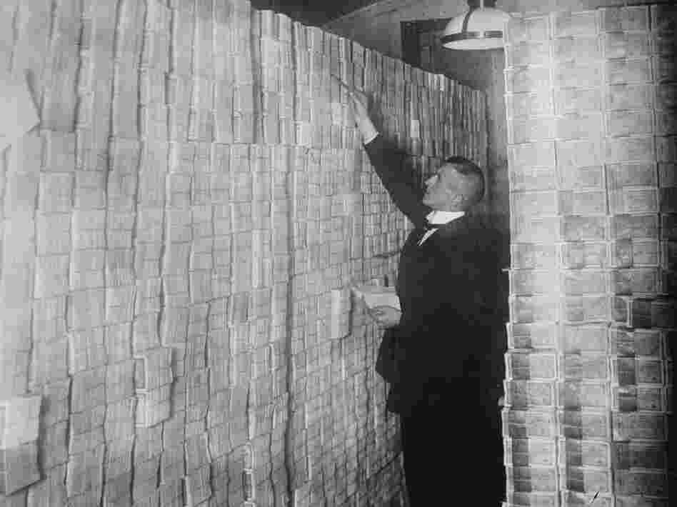 Paper money is stacked in a Berlin Bank in 1922. Paper money is stacked in a Berlin Bank in 1922.
