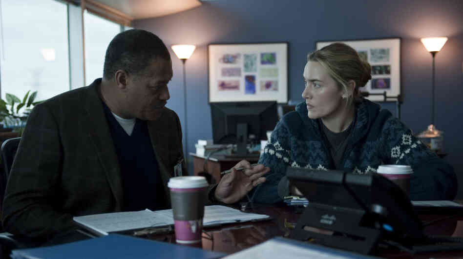 Laurence Fishburne as Dr. Ellis Cheever and Kate Winslet as Dr. Erin Mears in the thriller Contagion. Winslet's character was modeled on CDC epidemiologist Dr. Anne Schuchat.