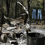 Jeans hang on a clothesline next to a burned down trailer home in Bastrop, Texas. A wildfire raging for nearly two weeks has blackened 50 square miles and destroyed more than 1,500 homes. Jeans hang on a clothesline next to a burned down trailer home in Bastrop, Texas. A wildfire raging for nearly two weeks has blackened 50 square miles and destroyed more than 1,500 homes.