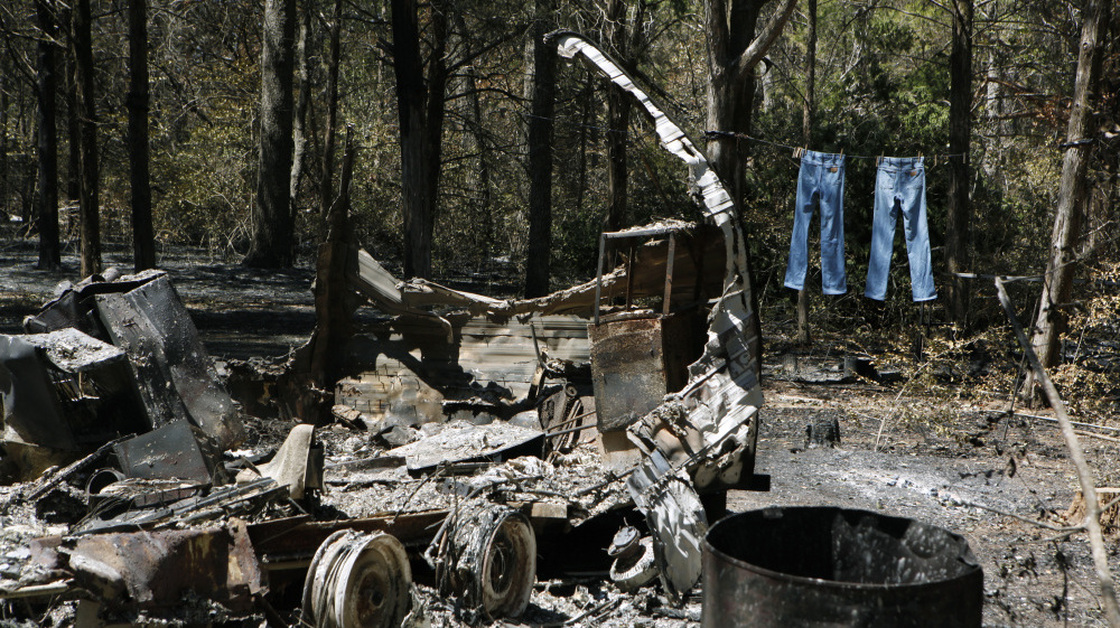 Jeans hang on a clothesline next to a burned down trailer home in Bastrop, Texas. A wildfire raging for nearly two weeks has blackened 50 square miles and destroyed more than 1,500 homes.
