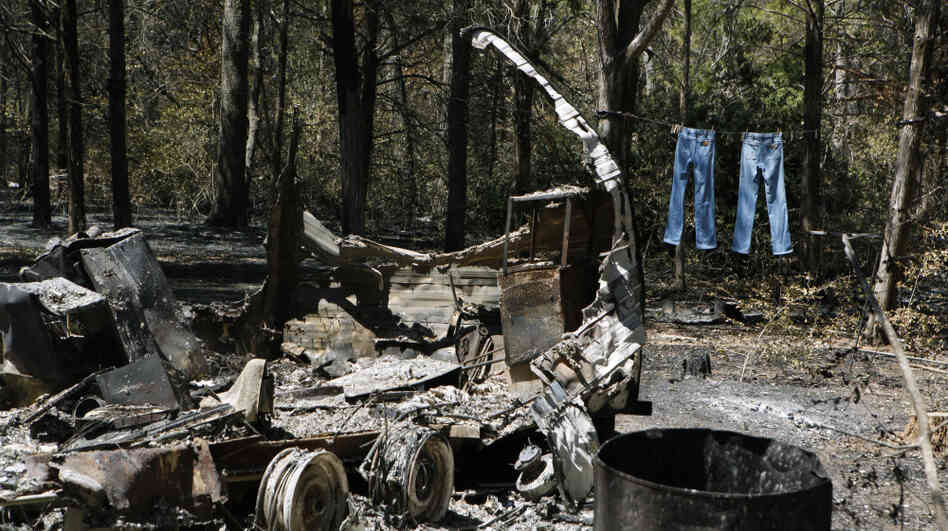 Jeans hang on a clothesline next to a burned down trailer home in Bastrop, Texas. A wildfire raging for nearly two weeks has blackened 50 square miles and destroyed more than 1,500 homes.