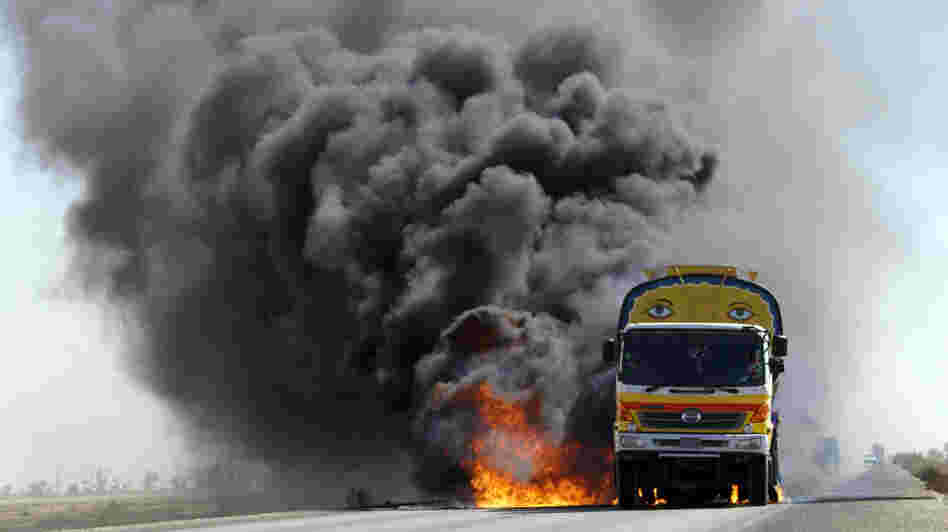 For the first seven years of the war in Afghanistan, almost all U.S. and NATO supplies were trucked overland to Afghanistan through parts of Pakistan effectively controlled by the Taliban. Here, smoke and flame rise from a burning NATO supplies oil tanker after armed militants torched the tankers in Mithri, Pakistan, in February. For the first seven years of the war in Afghanistan, almost all U.S. and NATO supplies were trucked overland to Afghanistan through parts of Pakistan effectively controlled by the Taliban. Here, smoke and flame rise from a burning NATO supplies oil tanker after armed militants torched the tankers in Mithri, Pakistan, in February.