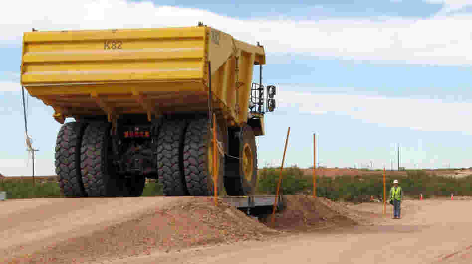 A large earth-mover carries PCB-contaminated soil from the Hudson River in New York to a burial pit at Waste Control Specialists near Andrews, Texas, in October 2009. A large earth-mover carries PCB-contaminated soil from the Hudson River in New York to a burial pit at Waste Control Specialists near Andrews, Texas, in October 2009.