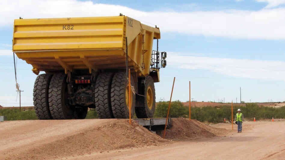 A large earth-mover carries PCB-contaminated soil from the Hudson River in New York to a burial pit at Waste Control Specialists near Andrews, Texas, in October 2009. A large earth-mover carries PCB-contaminated soil from the Hudson River in New York to a burial pit at Waste Control Specialists near Andrews, Texas, in October 2009.