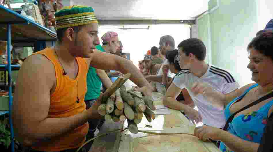 An employee sells products in a religious articles store in Havana, Cuba, in this file photo from January. After Cuban President Raul Castro authorized private businesses as part of economic reforms, Cubans are making their debut as small business owners.