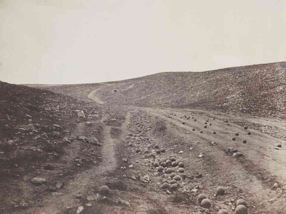 Some believe photographer Roger Fenton placed the cannonballs on the Ukrainian road during the Crimean War himself. Some believe photographer Roger Fenton placed the cannonballs on the Ukrainian road during the Crimean War himself.