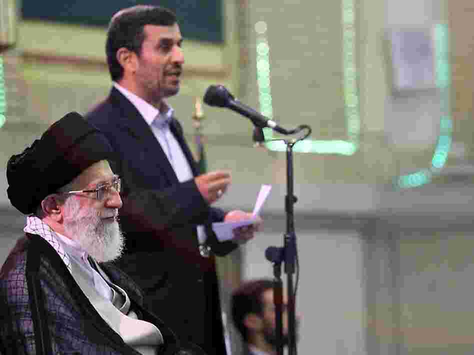 A handout picture released by the official website of Iran's Supreme Leader Ayatollah Ali Khamenei shows Khamenei listening to a speech by President Mahmoud Ahmadinejad (back) during a ceremony with other Iranian top officials and foreign ambassadors to mark the Muslim Eid al-Fitr feast in Tehran on Aug. 31, 2011.
