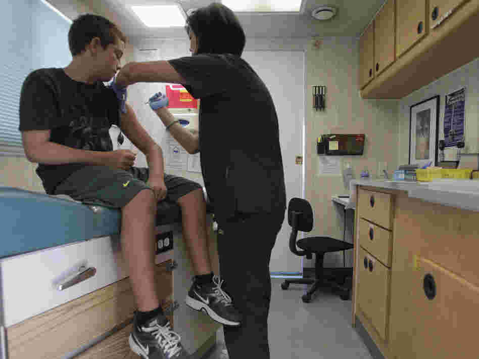 Trevor Reese, 13, gets his diphtheria, tetanus and pertussis booster shot from pediatric nurse practitioner Jenny Lu in Tustin, Calif., in August. Trevor Reese, 13, gets his diphtheria, tetanus and pertussis booster shot from pediatric nurse practitioner Jenny Lu in Tustin, Calif., in August.