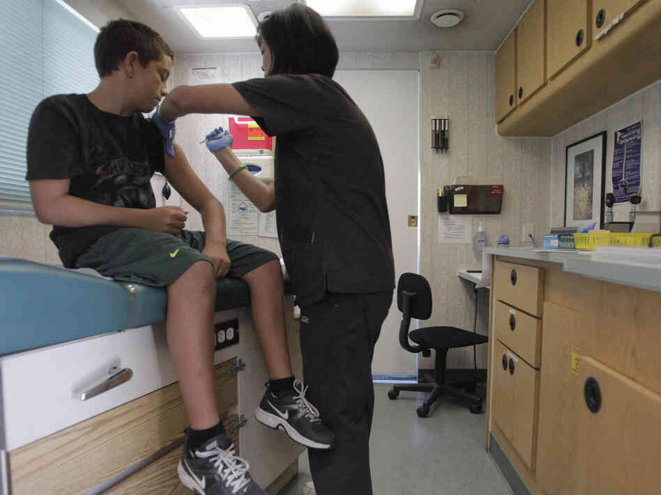 Trevor Reese, 13, gets his diphtheria, tetanus and pertussis booster shot from pediatric nurse practitioner Jenny Lu in Tustin, Calif., in August. Trevor Reese, 13, gets his diphtheria, tetanus and pertussis booster shot from pediatric nurse practitioner Jenny Lu in Tustin, Calif., in August.