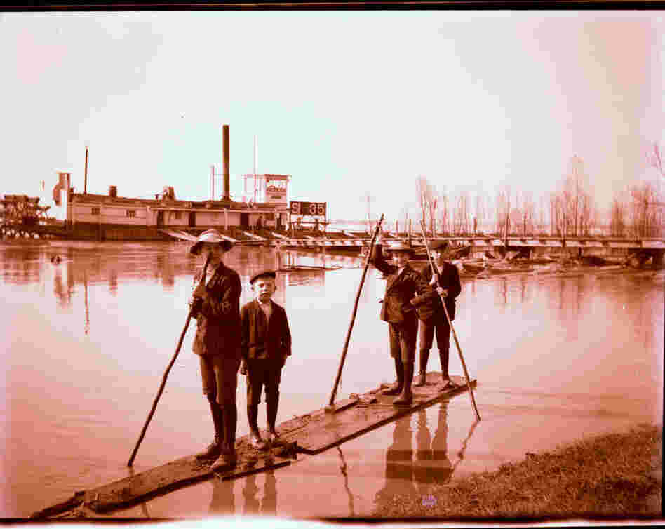 Boys on a raft near the batture.