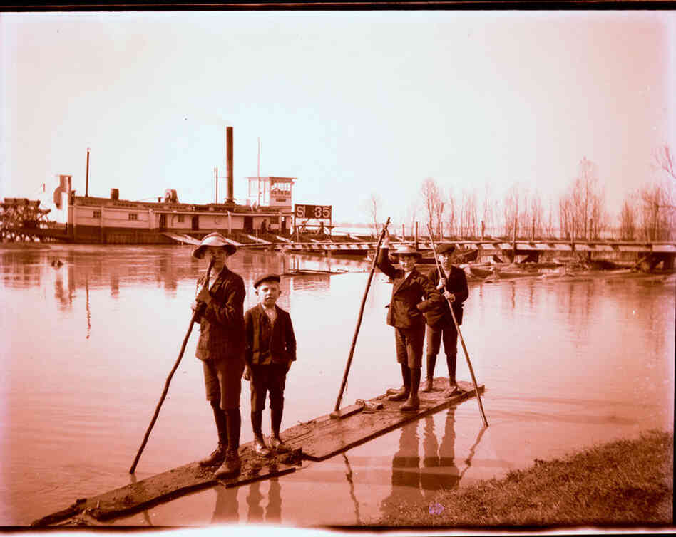 Boys on a raft near the batture.