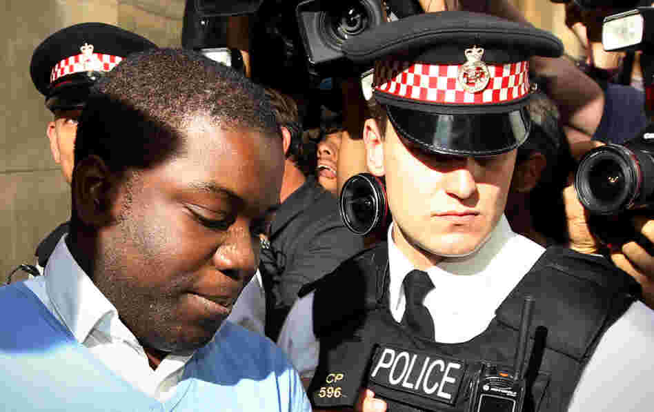 UBS equities trader Kweku Adoboli (L) is led into a prison van as he leaves City of London Magistrates Court in central London on Friday. UBS equities trader Kweku Adoboli (L) is led into a prison van as he leaves City of London Magistrates Court in central London on Friday.
