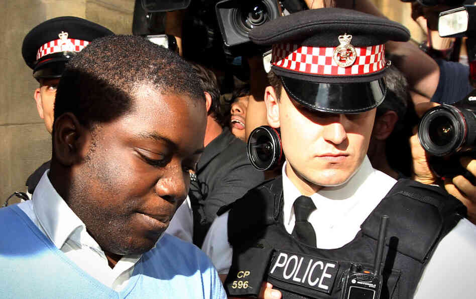 UBS equities trader Kweku Adoboli (L) is led into a prison van as he leaves City of London Magistrates Court in central London on Friday. UBS equities trader Kweku Adoboli (L) is led into a prison van as he leaves City of London Magistrates Court in central London on Friday.