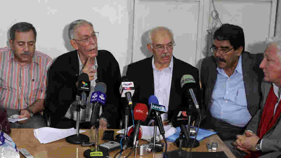 More than 300 Syrian dissidents met near Damascus on Sunday, and afterward they held a news conference and called for more protests to oust President Bashar Assad's government. From left: Rajaa Nasser, Hussein Awdat, Hassan Abdul Azim, Saleh Mohammed and Samir Aita.