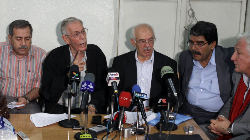 More than 300 Syrian dissidents met near Damascus on Sunday, and afterward they held a news conference and called for more protests to oust President Bashar Assad's government. From left: Rajaa Nasser, Hussein Awdat, Hassan Abdul Azim, Saleh Mohammed and Samir Aita.