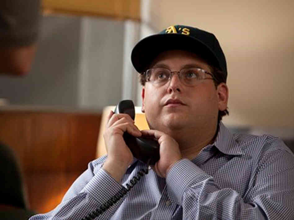 Jonah Hill takes on a surprisingly more serious role than his previous work as Peter Brand, an overachieving Ivy League geek who likes to crank statistics on everyone. Jonah Hill takes on a surprisingly more serious role than his previous work as Peter Brand, an overachieving Ivy League geek who likes to crank statistics on everyone.