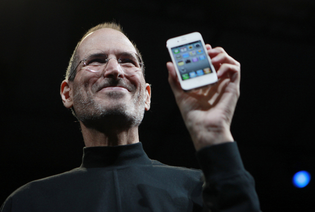 Steve Jobs holds up an iPhone at the Apple Worldwide Developers Conference in San Francisco in June 2010.