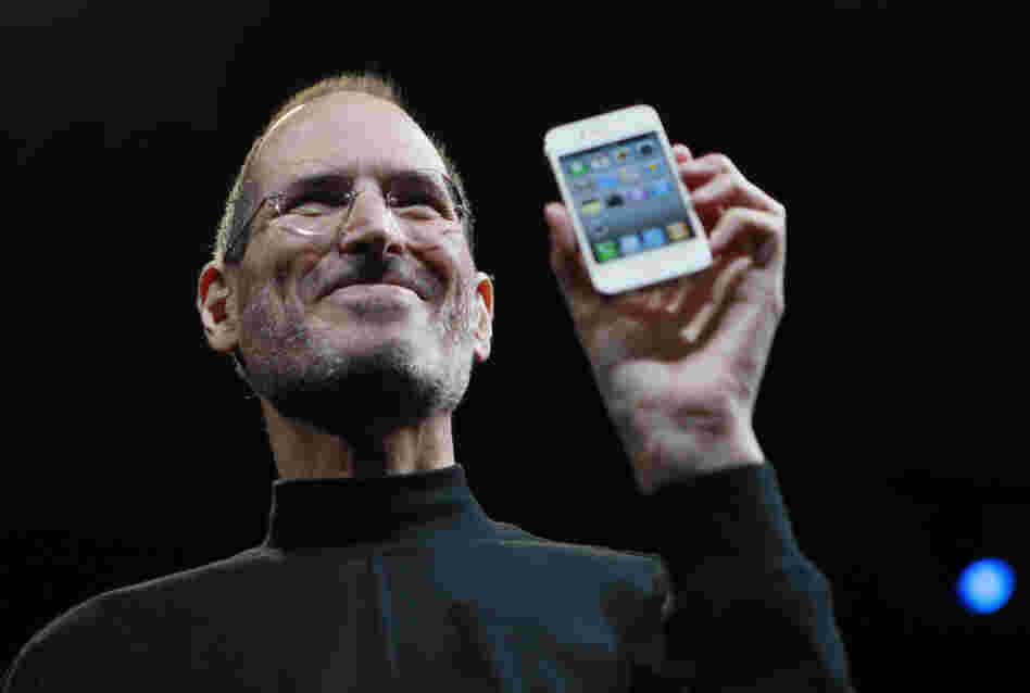 Steve Jobs holds up an iPhone at the Apple Worldwide Developers Conference in San Francisco in June 2010.