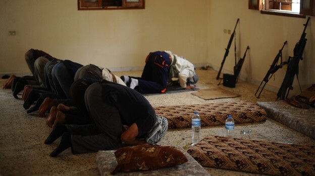 Libyan rebels pray before going out on patrol outside the port city of Misrata on April 30. Religion plays a major role in Libyan life, and Islamist groups want to be part of the new government.