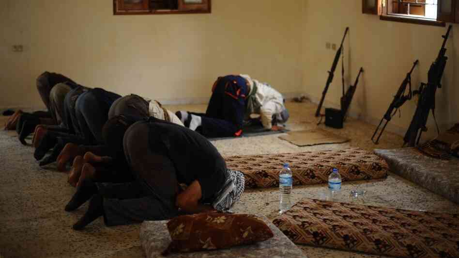 Libyan rebels pray before going out on patrol outside the port city of Misrata on April 30. Religion plays a major role in Libyan life, and Islamist groups want to be part of the new government.