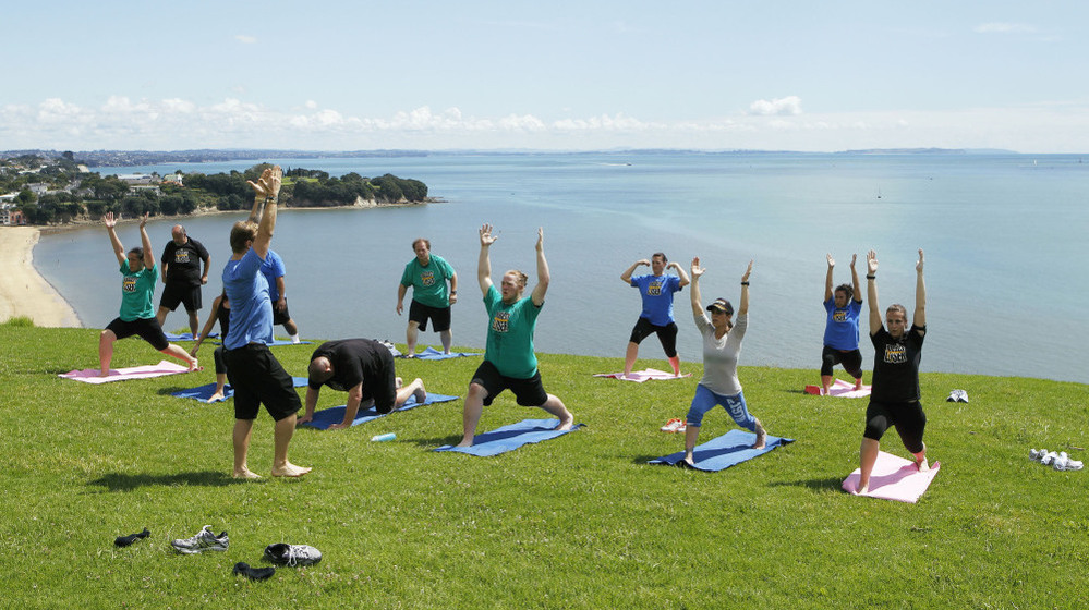 Contestants from NBC's "The Biggest Loser" do yoga in Auckland, New Zealand.