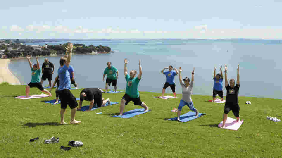 Contestants from NBC's "The Biggest Loser" do yoga in Auckland, New Zealand.