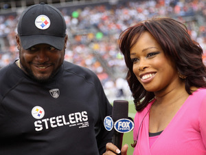 Pam Oliver,  sideline reporter for Fox Sports, interviews head coach Mike Tomlin of  the Pittsburgh Steelers as he leads his team against the Denver Broncos.