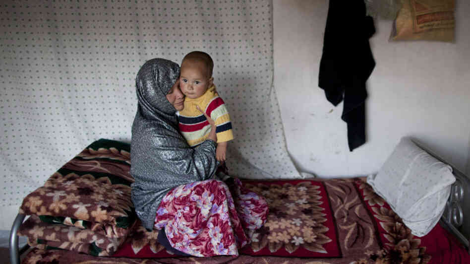 Sakina sits with her 18-month-old son, Shafiq, at a women's shelter in Bamiyan, in central Afghanistan, last October. Sakina spent seven months in prison for leaving a forced marriage. The Afghan government recently backed down from a plan to take control of women's shelters, and women's groups are hailing it as a victory.