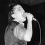 Bikini Kill onstage in New York City in 1994. Kathleen Hanna singing,  Kathi Wilcox on bass behind her.